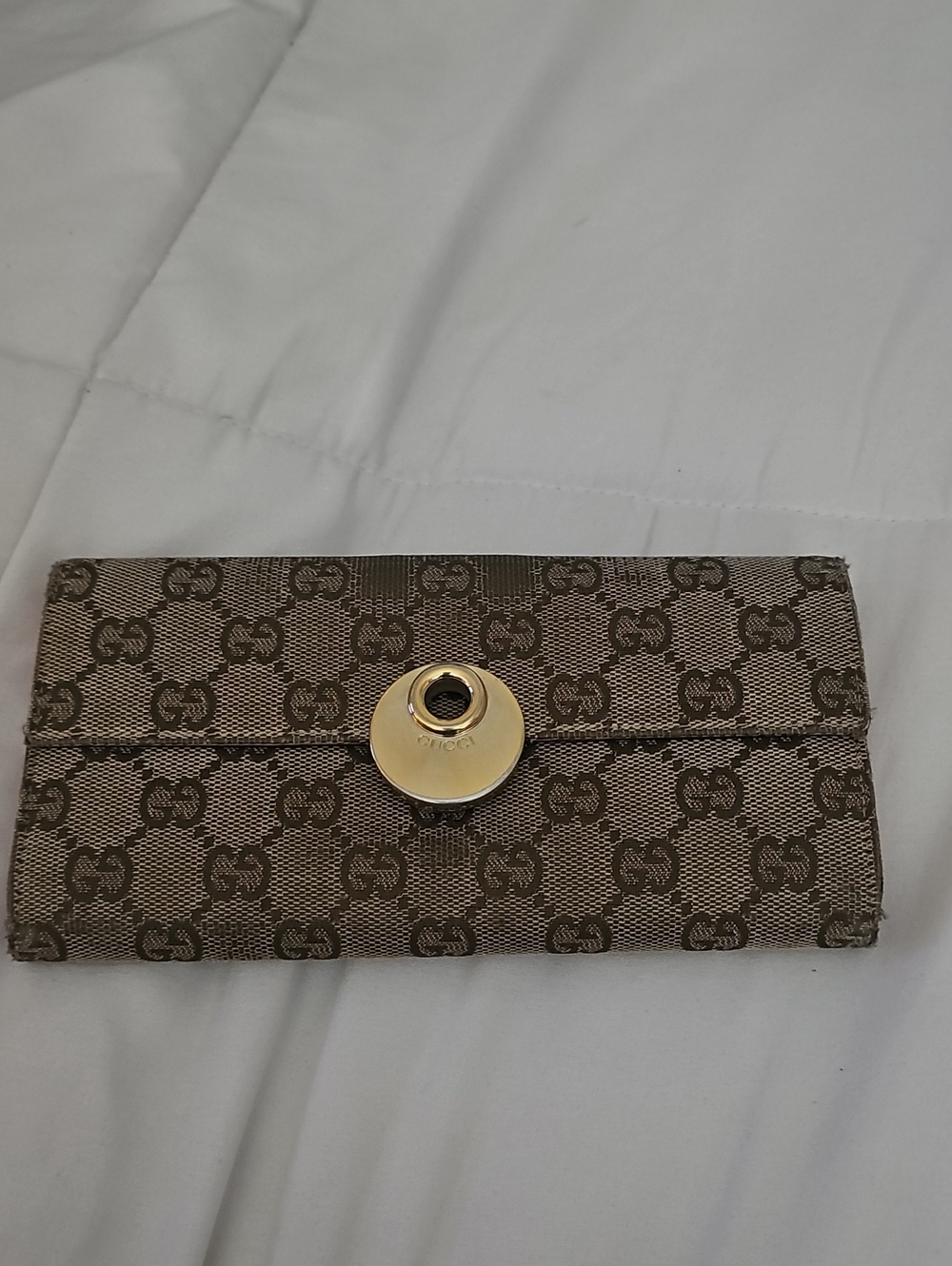 Gucci brown monogram wallet with gold circular clasp